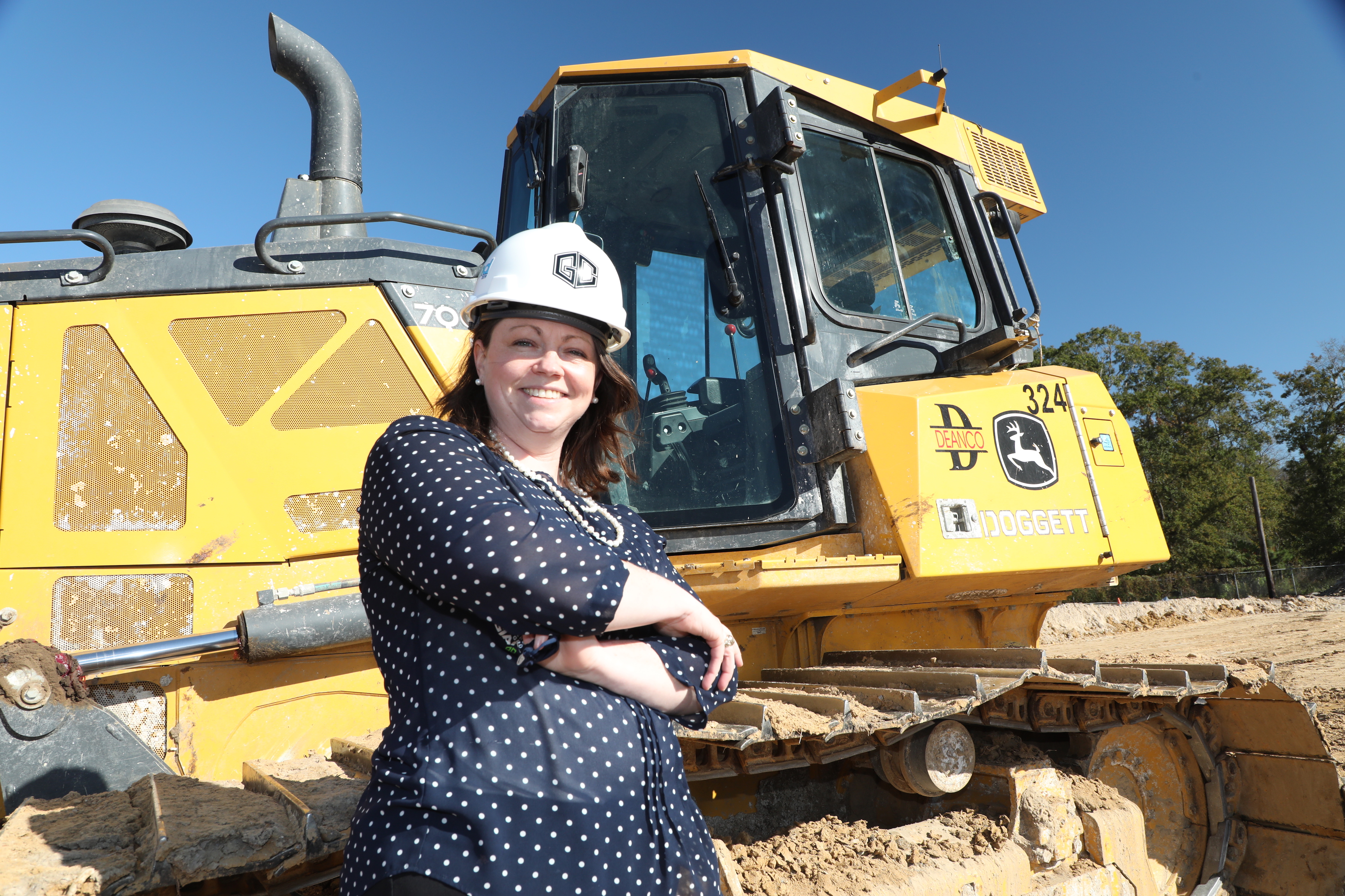 Rachel McAdam poses in front of future san jacinto site